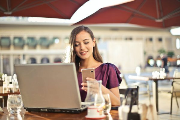 Woman on phone & laptop